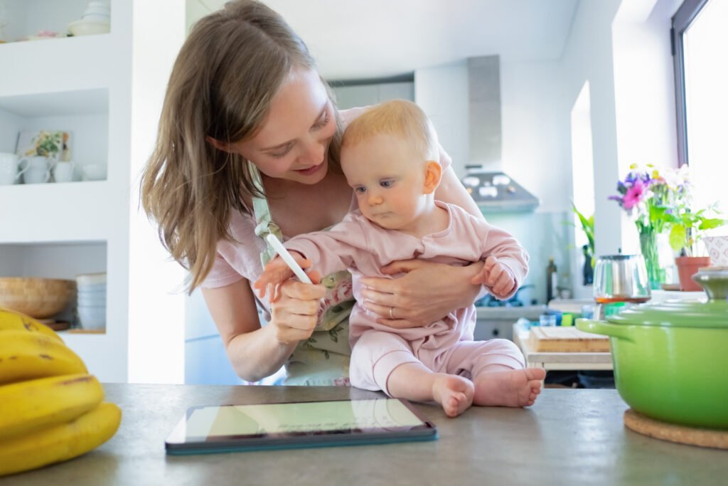 Mom and baby daughter cooking together at home